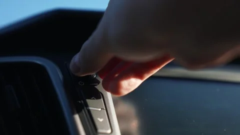 Auto technology concept.close-up of hands turning volume button of car radio Video stock 254852542