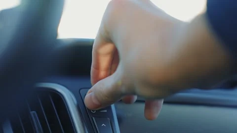 Auto technology concept.close-up of hands turning volume button of car radio Stock Footage 264138824
