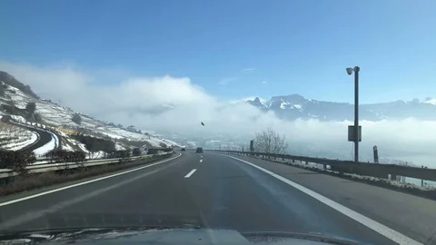 On the autobahn through the  cloudy mountains Stock Footage 86989610