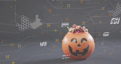 Autofocus starting hex clusters shifting around carved pumpkin bowl candies Stock Footage 328146095