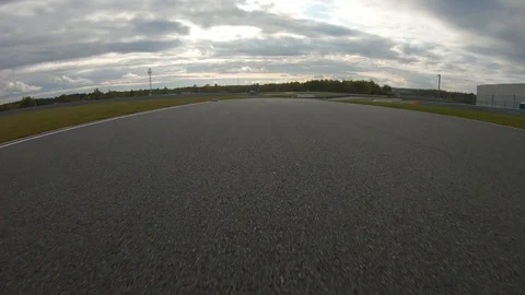 Autogrip. Car mounted camera pov shot as a car drives around raceway Stock Footage 128403529