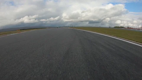 Autogrip. Car mounted camera pov shot as a car drives around raceway Stock Footage 128403538