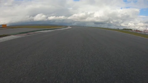 Autogrip. Car mounted camera pov shot as a car drives around raceway Stock Footage 128403580
