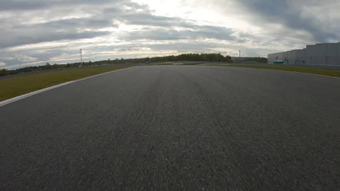 Autogrip. Car mounted camera pov shot as a car drives around raceway Stock Footage 128403611