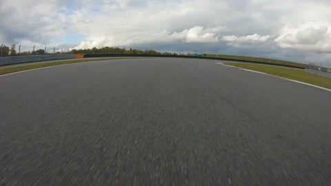 Autogrip. Car mounted camera pov shot as a car drives around raceway Stock Footage 128403763