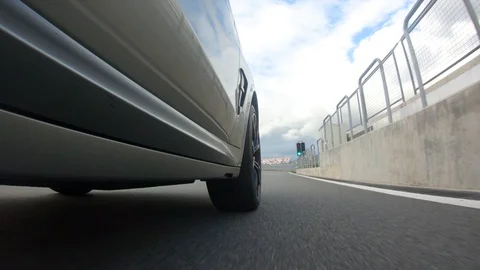 Autogrip. Car mounted camera pov shot. View at the front wheel Stock Footage 128403799