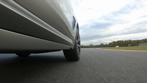Autogrip. Car mounted camera pov shot. View at the front wheel Stock Footage 128403874