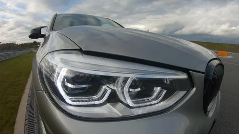Autogrip. Car mounted camera view of the headlight Stock Footage 128403835