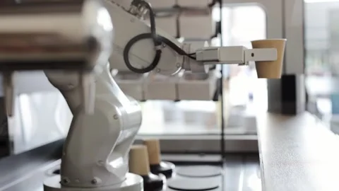 Automated cafe with robotic arm serving beverage. Iced coffee being made. Video stock 330882665