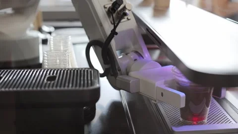 Automated cafe with robotic arm serving beverage. Iced coffee being made. Video stock 330882698