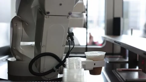 Automated cafe with robotic arm serving beverage. Video stock 330883227