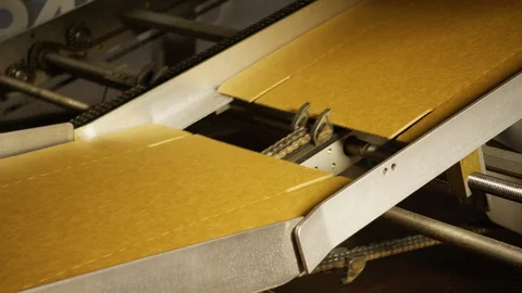 Automated cardboard assembly machine conveyor transporting box to be built A Video stock 112883110