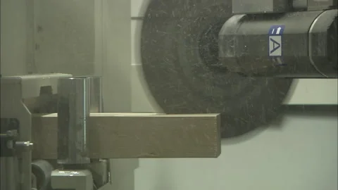 Automated circular saw cutting timber in industrial lumber factory Stockbeeldmateriaal 329685222