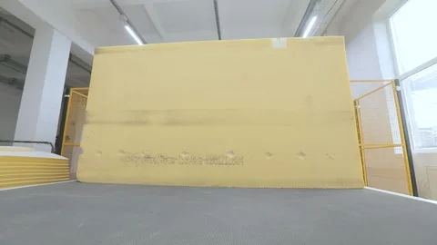 Automated CNC foam cutting machine processing a large block of polyurethane foam Vídeo Stock 344988696