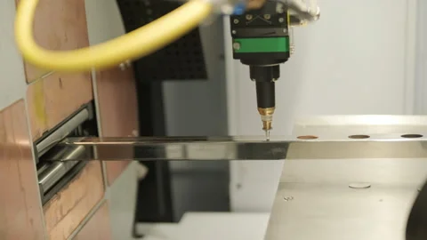 Automated CNC laser cutting machine processing a square metal pipe with bright Stock Footage 345892655
