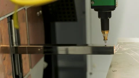 Automated CNC laser cutting machine processing a square metal pipe with bright Stock Footage 345892832