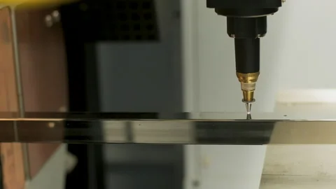 Automated CNC laser cutting machine processing a square metal pipe with bright Stock Footage 345892843