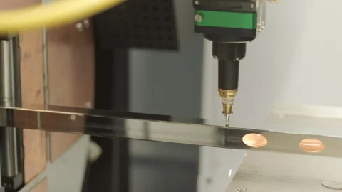 Automated CNC laser cutting machine processing a square metal pipe with bright Stock Footage 345892870