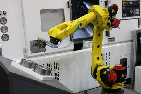 Automated CNC machine loading with robotic arm Stock Photos