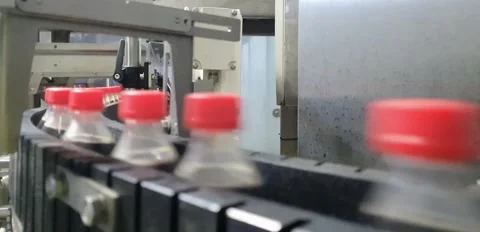 Automated Conveyor Line Transporting Bottled Drinks in Production Plant Stock Footage 316545543