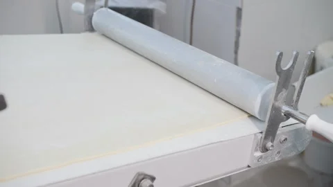 Automated Dough Rolling System on Conveyor, Industrial Bakery Production Stock Footage 321132315
