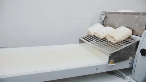 Automated Dough Sheeter on Conveyor Stock Footage 321132931