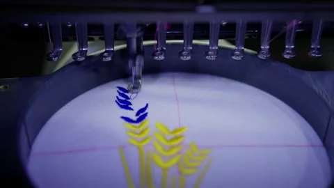 An automated embroidery machine makes a pattern on clothes Stock Footage 262066937