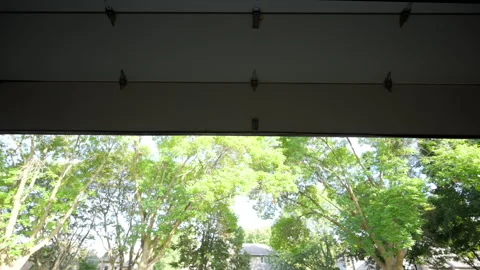 Automated garage Door opens and closes. View from inside of the residential Stock Footage 318630391