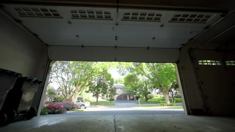Automated garage Door opens and closes. View on the street from inside of the Stock Footage 318762709