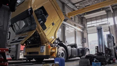 Automated lowering of the cab of a new freight truck at the factory Stock Footage 261289917