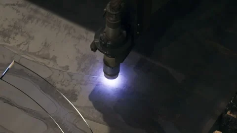 Automated machine cutting the circular shape out of metal material in a workshop Stock Footage 287490382