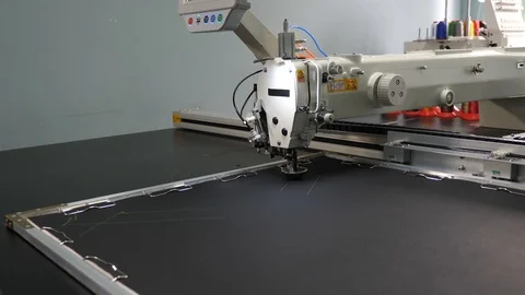 Automated machine embroider pattern on artificial leather. Robotics works in the Stock Footage 108067890
