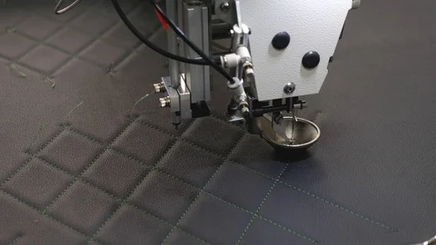 Automated machine embroider pattern on artificial leather. Robotics works in the Stock Footage 108372363