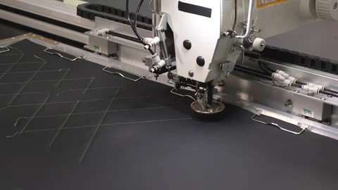 Automated machine embroider pattern on artificial leather. Robotics works in the Stock Footage 108518677