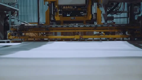 An automated machine at the factory moves the material Stock Footage 165949494