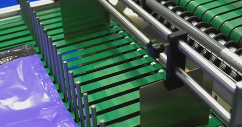 Automated machine folding purple plastic film on production line Stock Footage 302260389