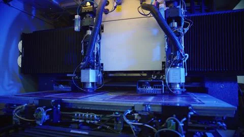 Automated machine processing circuit boards in futuristic factory Stock Photos