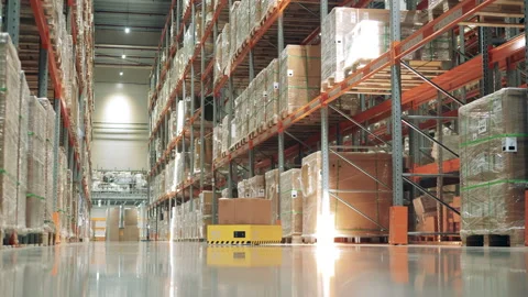 Automated machine is riding through the warehouse with a box Stock Footage 159344913