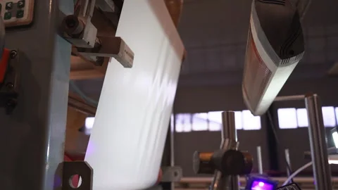 Automated machine tool rolls large plastic foil sheet Stock Footage 304390437