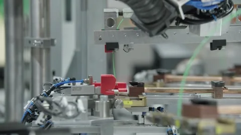 Automated manufacturing unit processing temperature sensor cable components Stock Footage 328830521