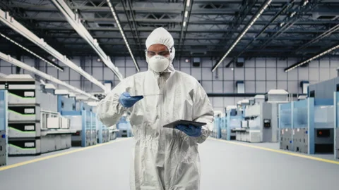 Automated microchip foundry lab technician assessing hardware fabrication Stock Footage 333392122