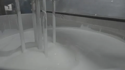 Automated Mixing Process of Viscous White Liquid in Vat Stock-Footage 330156097