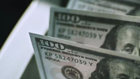 Automated money counting machine processing stacks of one hundred dollar bi.. Stock Footage 337441245