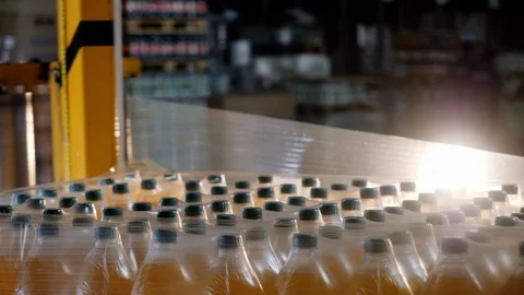 Automated packaging batch of bottles in beverage plant with plastic wrap closeup Stock Footage 122506537