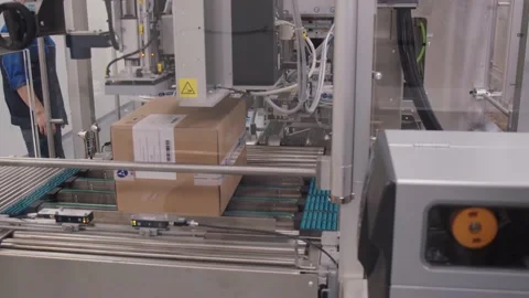 Automated packaging machine sealing cardboard box with the tape. packed carton Stock Footage 200857040