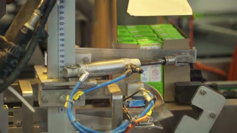 Automated Packing Machine Puts Milk Cartons Into Unfolded Boxes At Dairy Plant Stock Footage 204985330