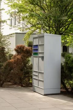 Automated parcel locker terminal for package delivery standing in urban area Stock Photos