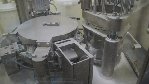 Automated pharma equipment in the process of encapsulation blue capsules. pill Stock Footage 200856181