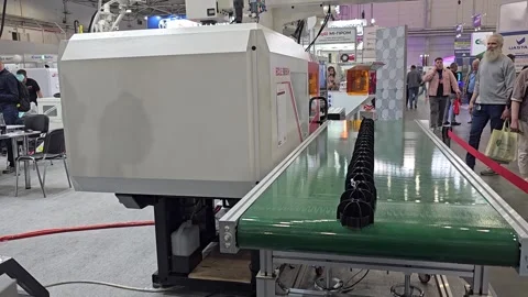 Automated Plastic Injection Molding Machine with Robotic Arm and Conveyor Belt Stock Footage 341852975