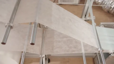 Automated process of gluing the insulating layers of protective mask in factory Stock Footage 204038896